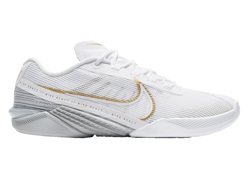 White nike trainers with gold cheap tick